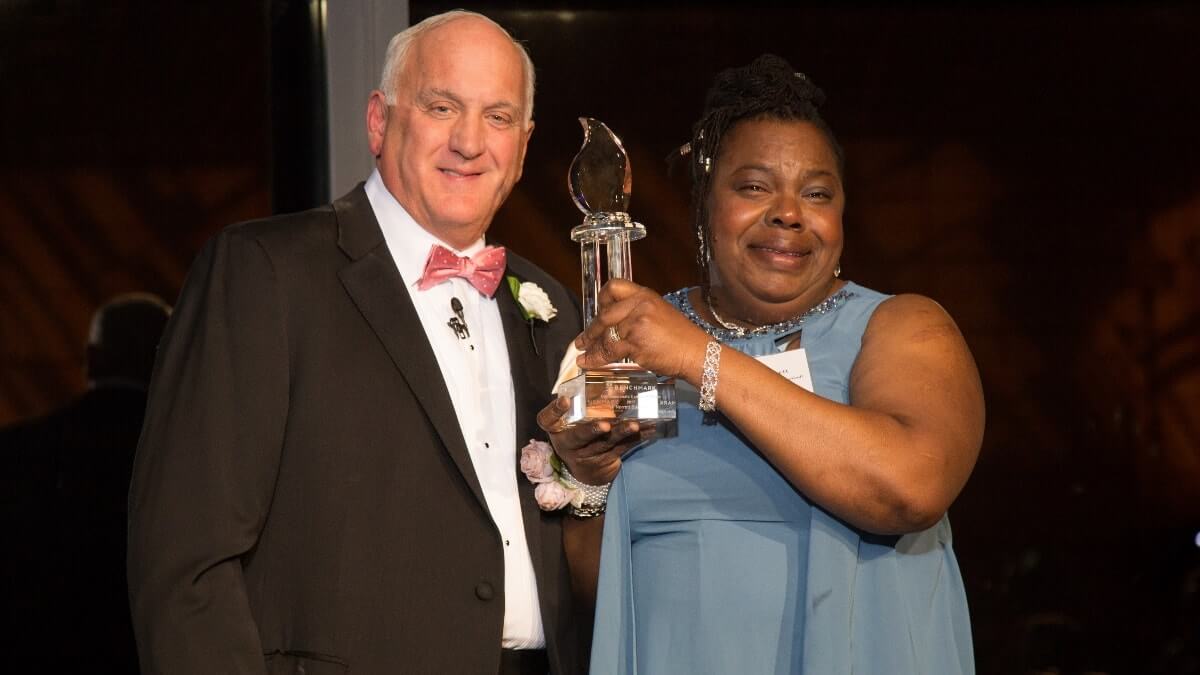 Woman receiving award at gala