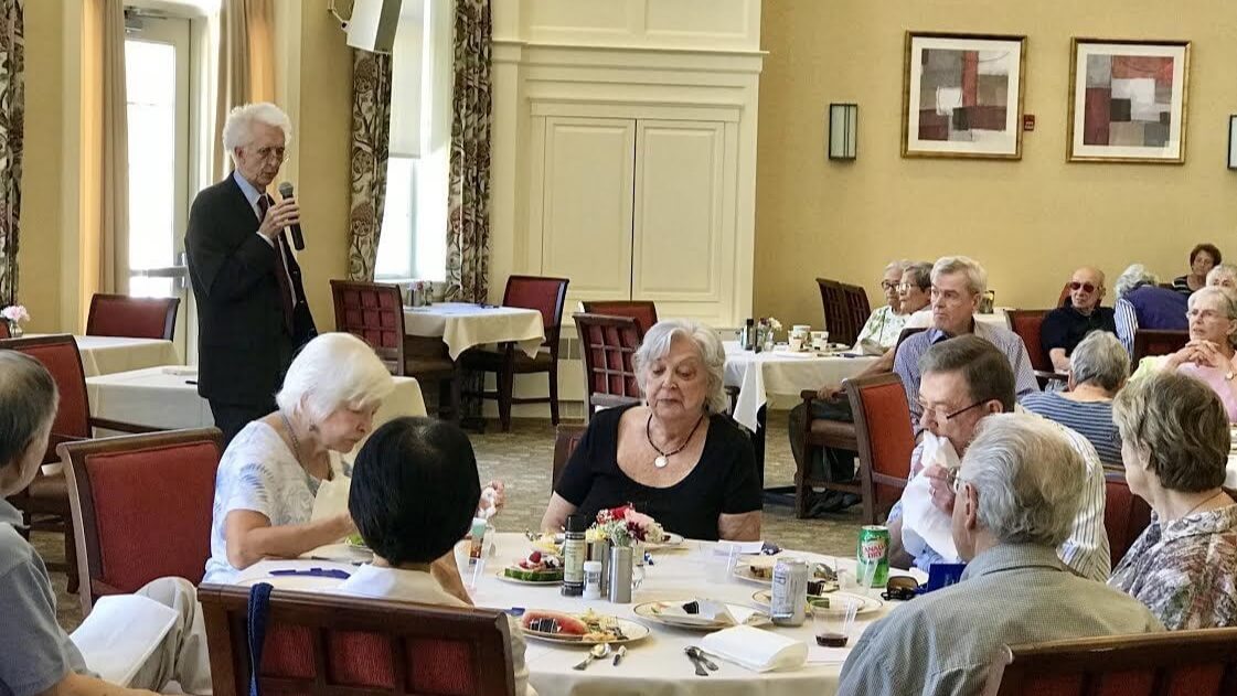 Man speaking to group of seniors