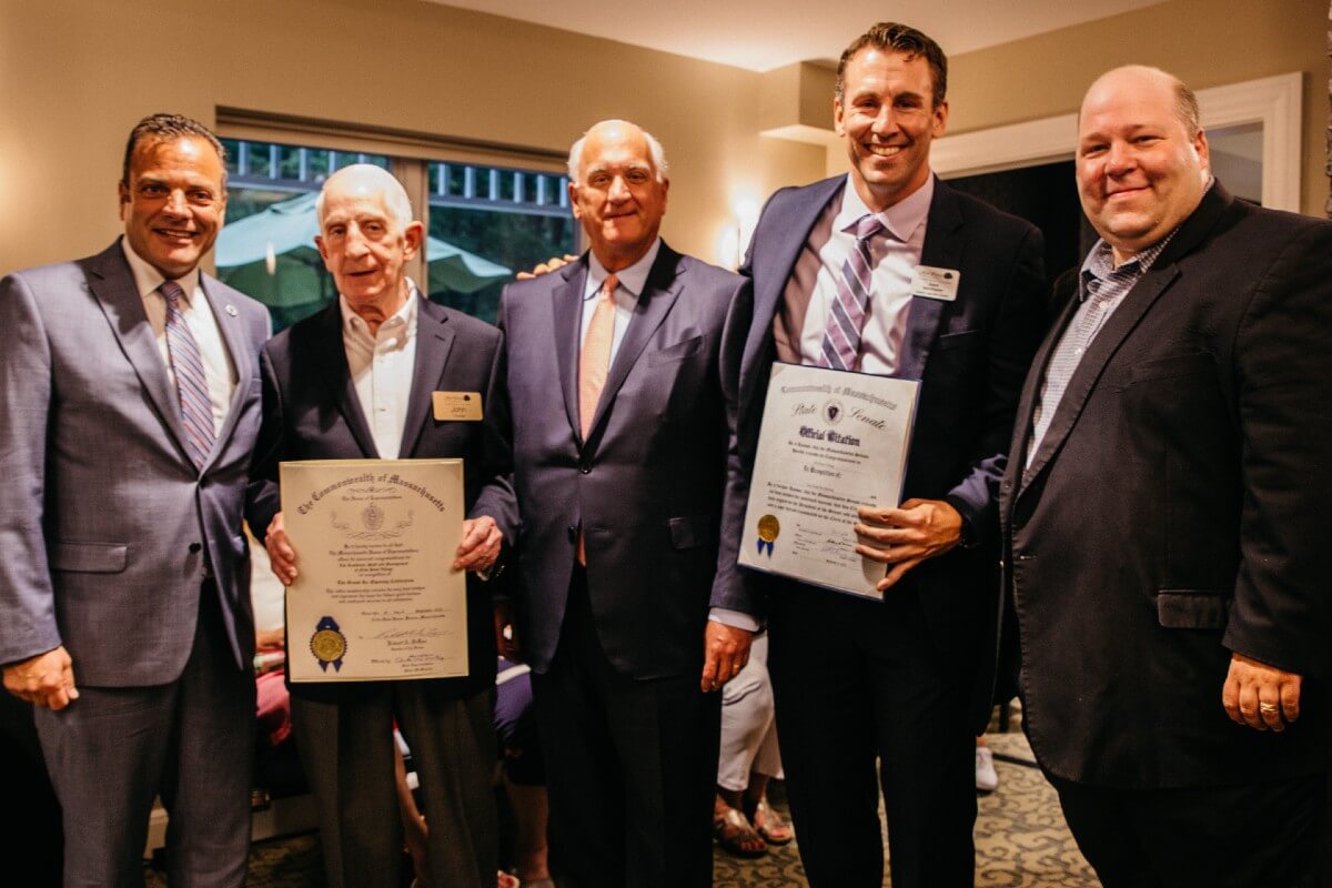 Group of men at senior home grand opening event