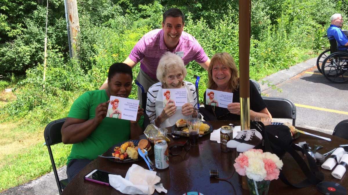 Adults at charity table outdoors