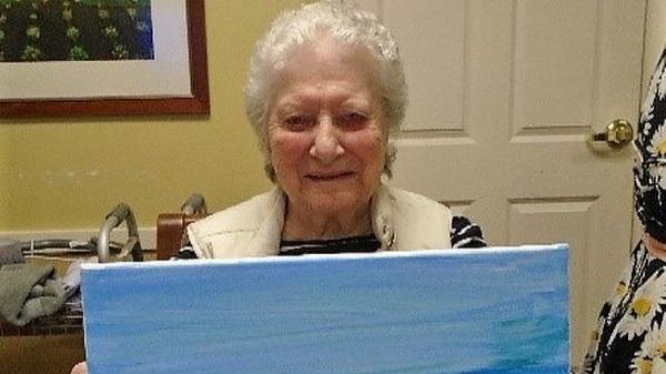 Senior woman holding painting