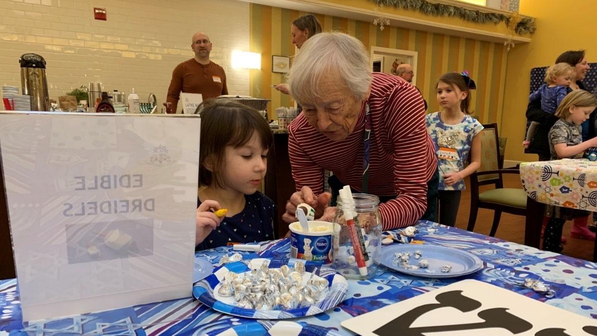 Senior woman and young girl doing arts and crafts