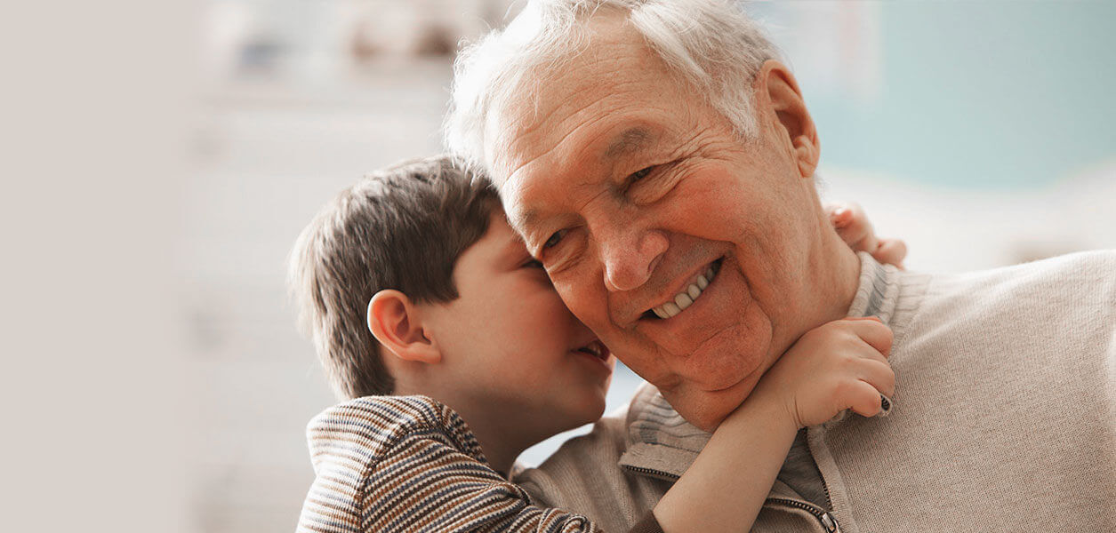 Grandson whispering in grandfather's ear