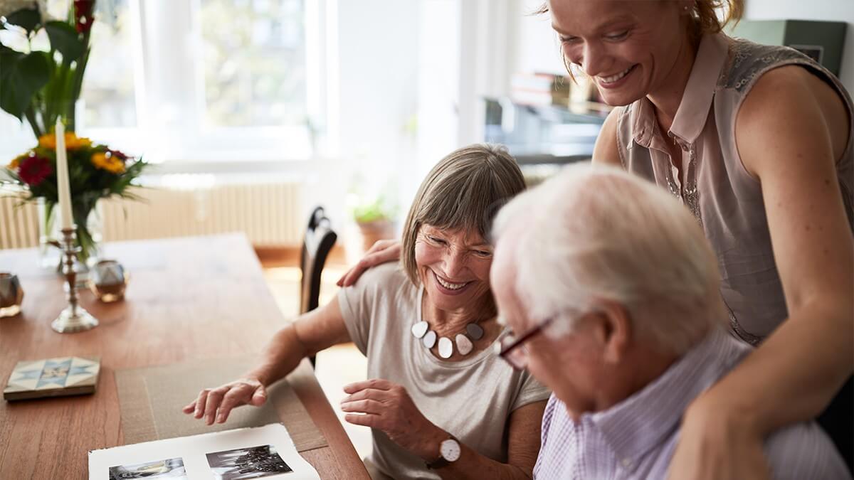 Adults looking at photo album