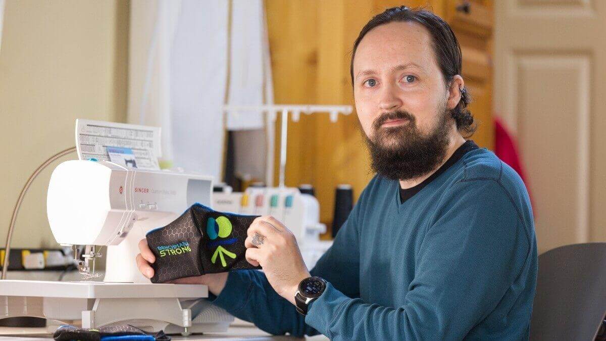 Man holding sewn facemask