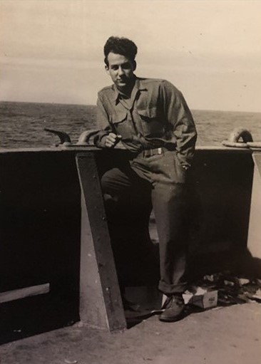 Old photo of man on ship in armed services uniform
