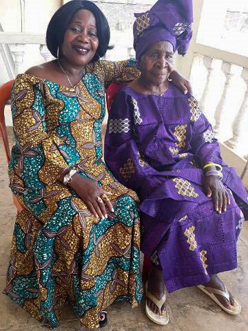 Woman and older woman posing for photo in traditional African attire