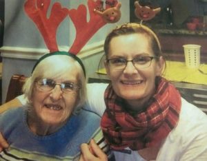 Woman and older woman wearing reindeer hats