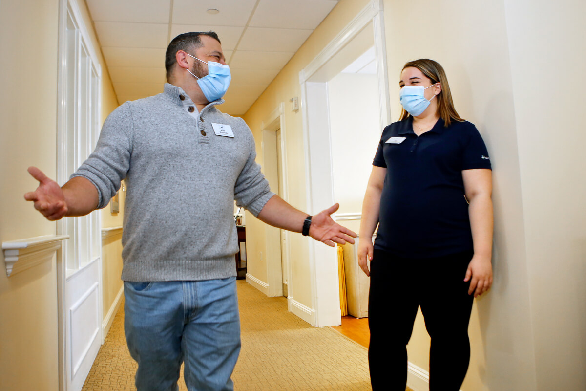 Man and woman speaking to each other in senior home