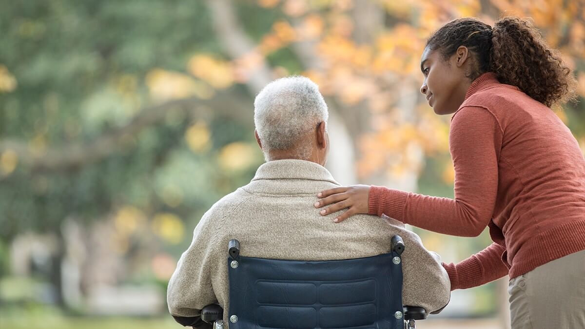 Woman and older man in wheelchair