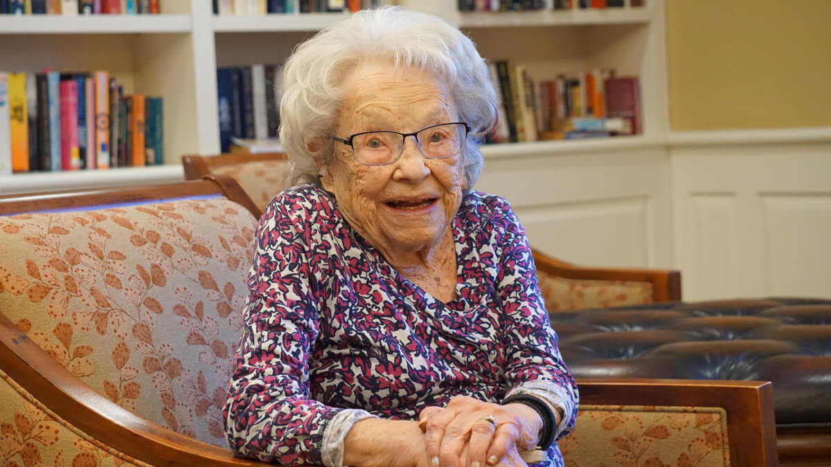Senior woman posing for photo in library room