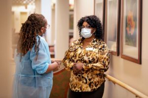 Two female nurses speaking to each other