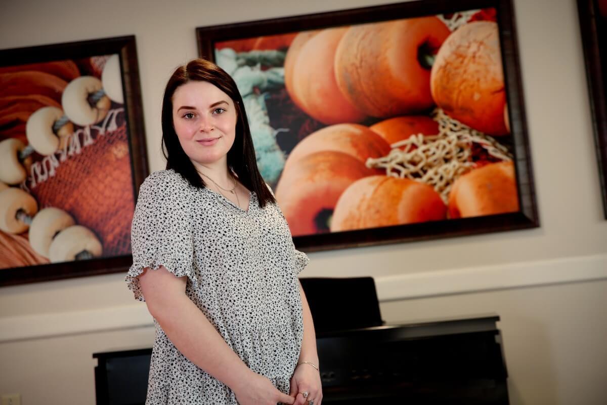 Young woman posing for photo in senior living facility