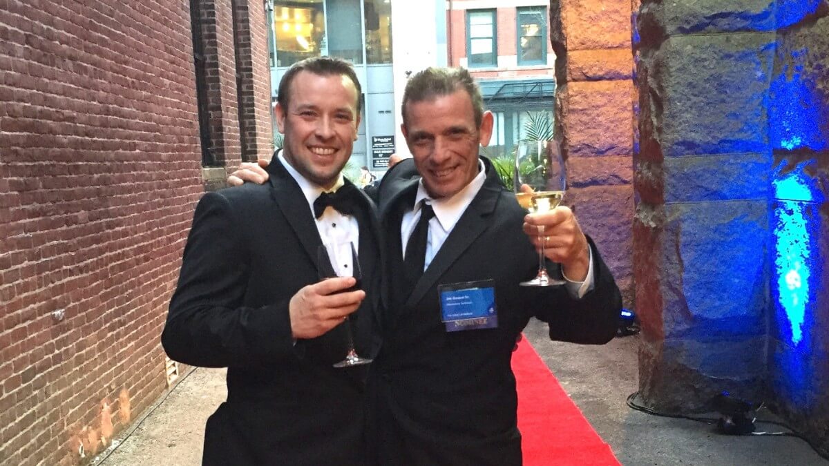 Two men in black tie attire at awards show
