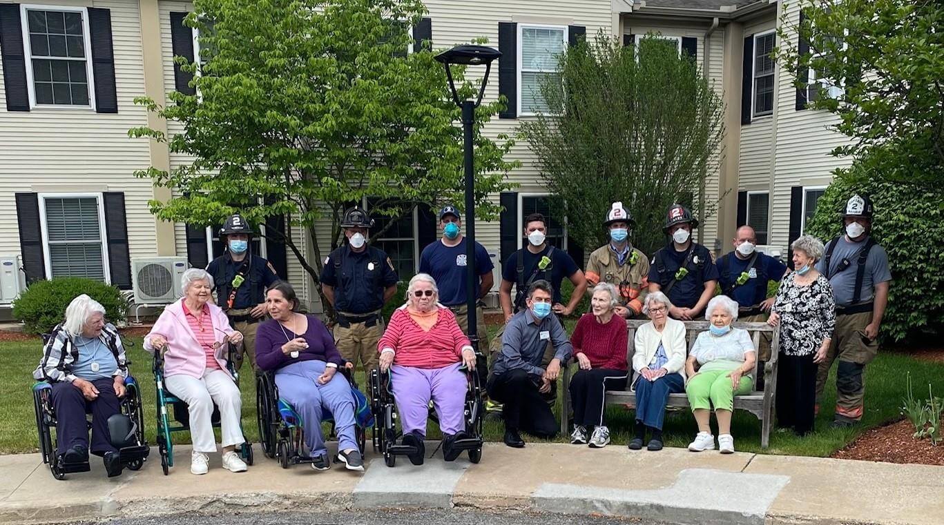 Group of seniors and firefighters outdoors