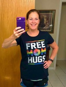 Woman taking selfie wearing Pride shirt