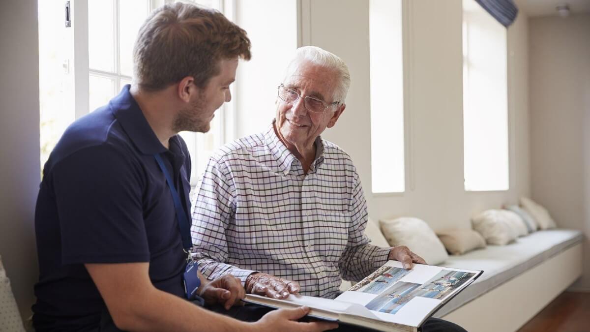 Man and senior man looking at photo album