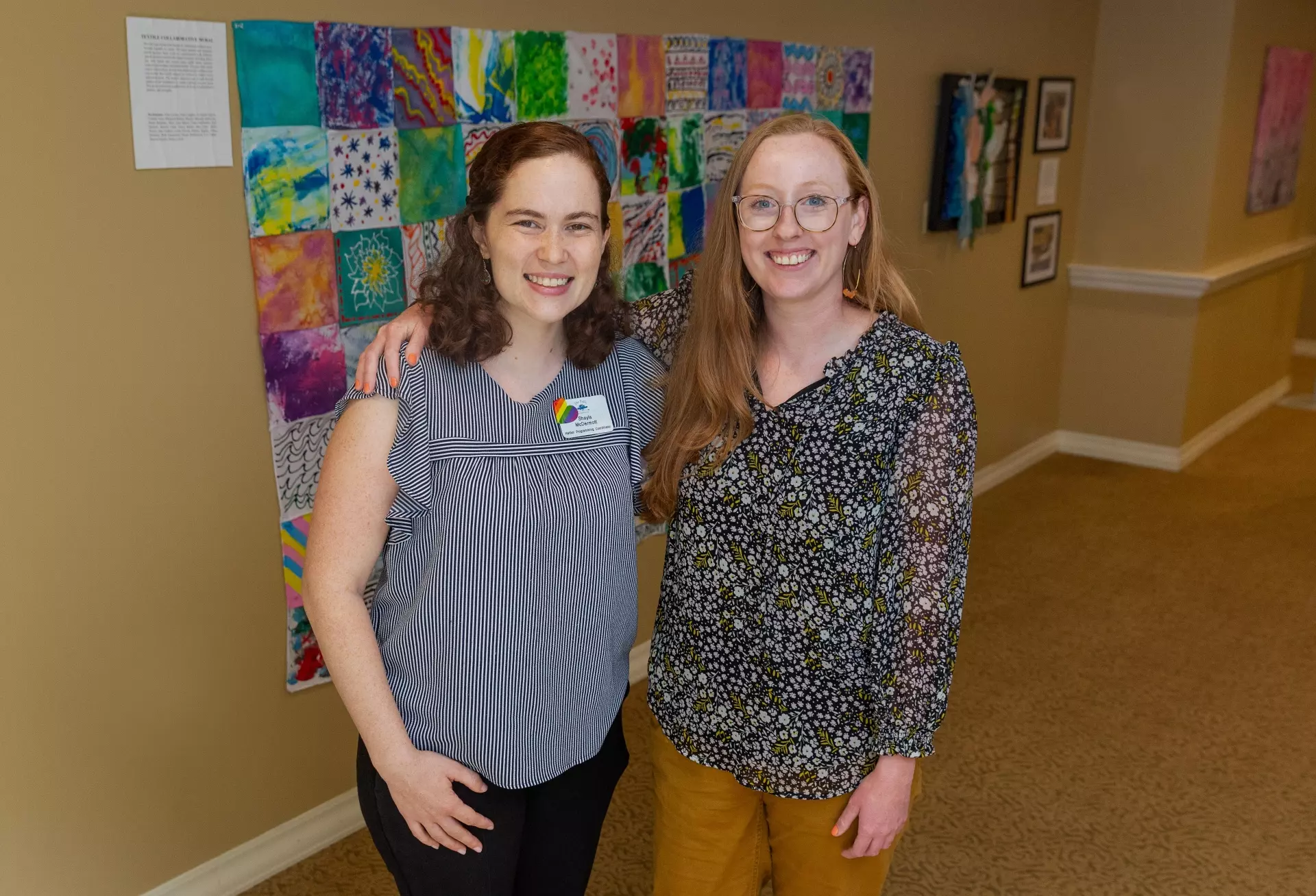 Two women posing for picture in senior home