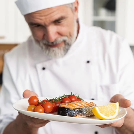 Chef holding plate of fish
