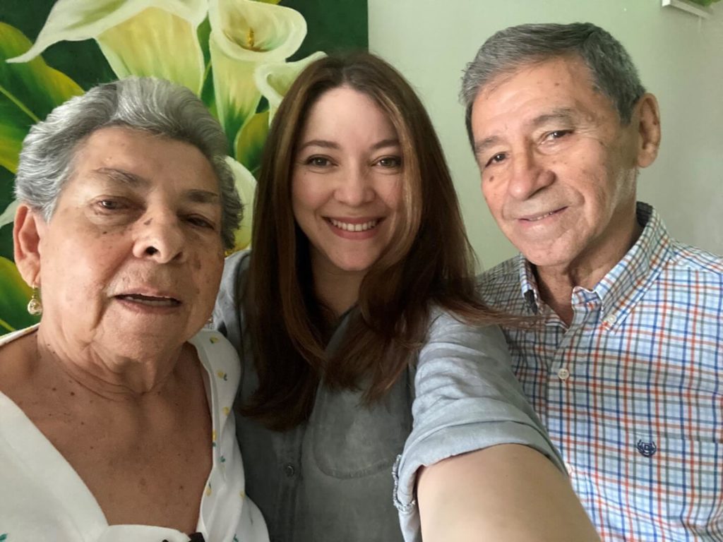 Woman and senior couple posing for photo