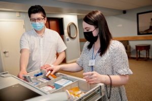 Man and woman arranging medication