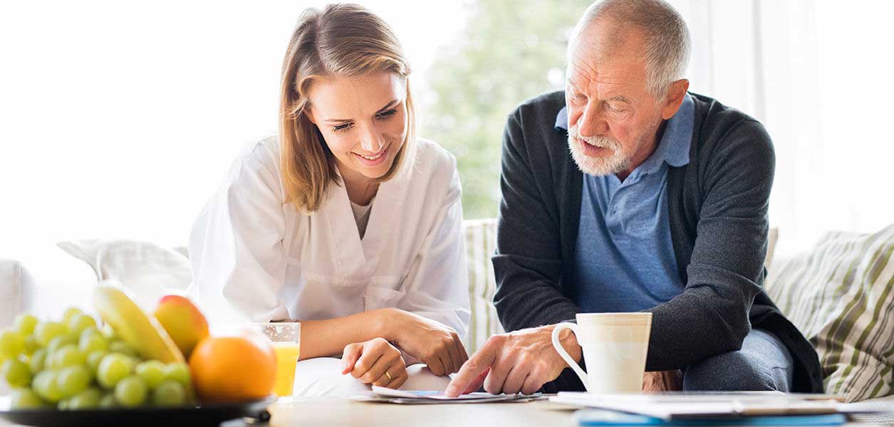 Nurse and man reading documents