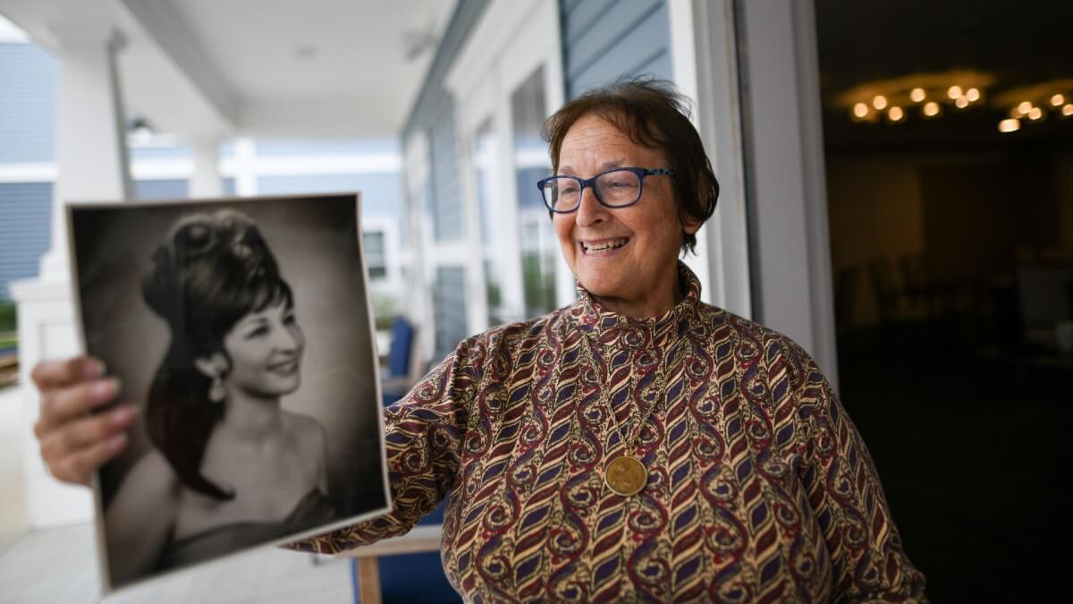 Woman holding black and white photo