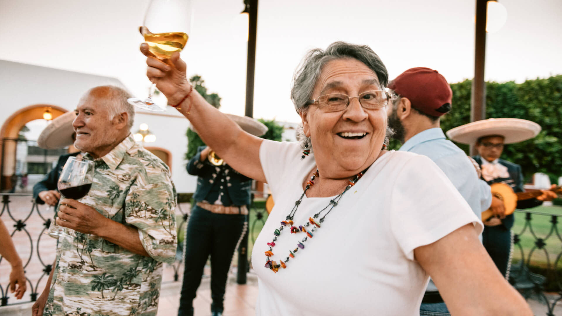 Woman holding a glass of wine and dancing