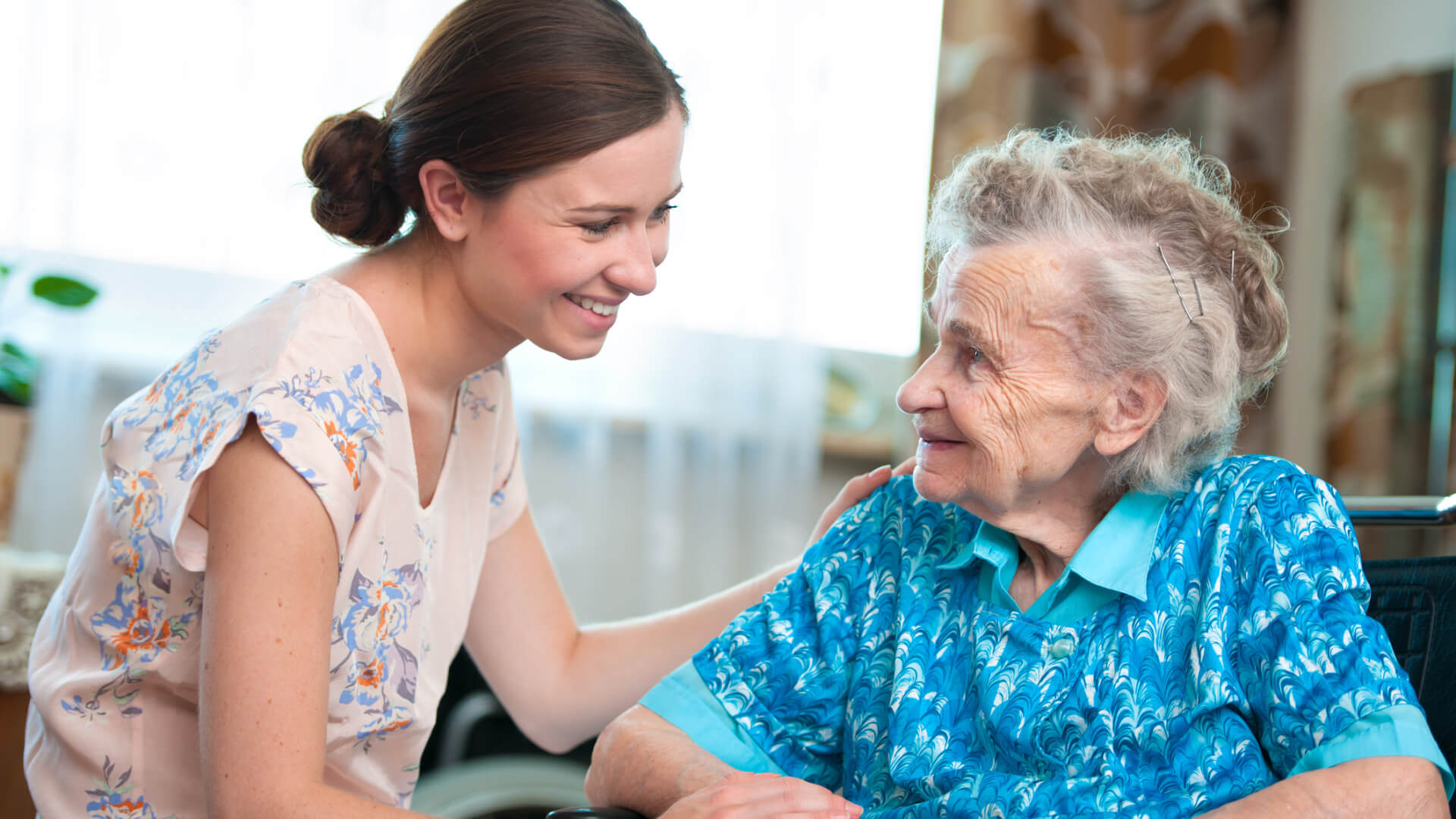 Senior woman with her caregiver at home