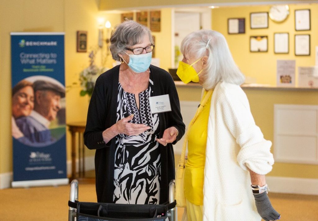 Senior living staff speaking with resident