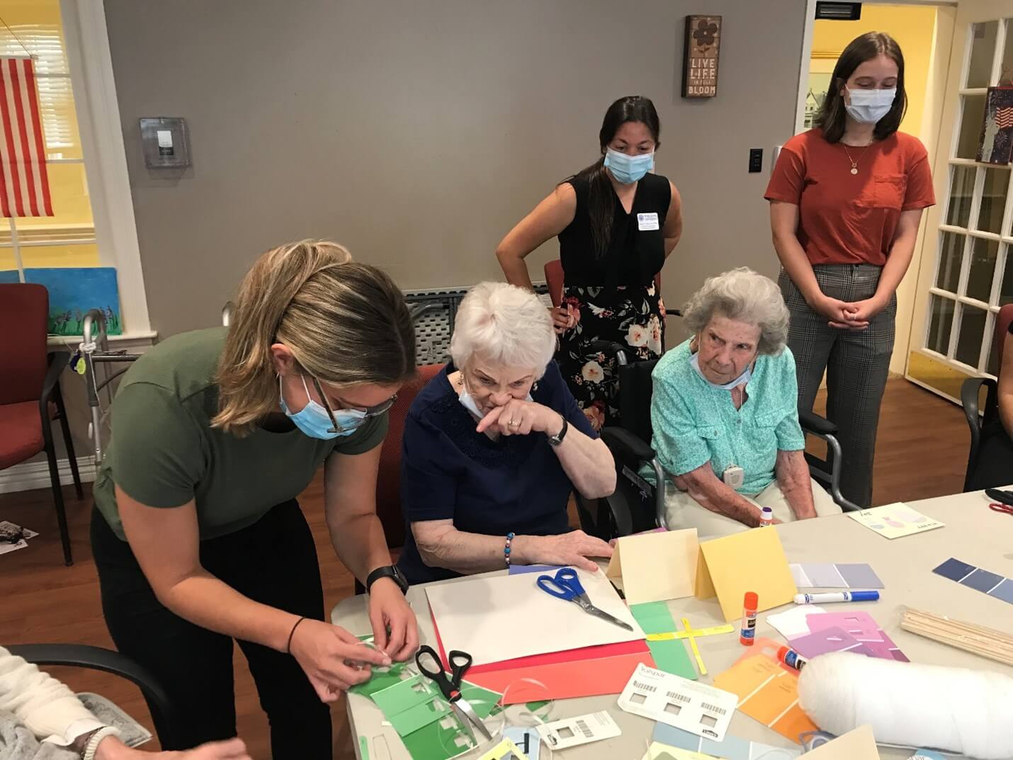 College students helping seniors with artwork