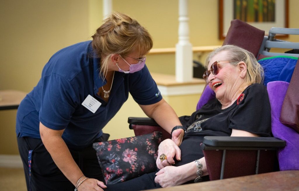 Caregiver helping senior resident