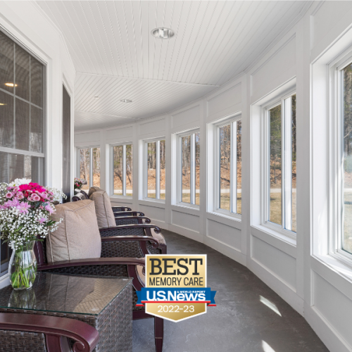 Benchmark at Rye sunroom with many windows and comfortable chairs