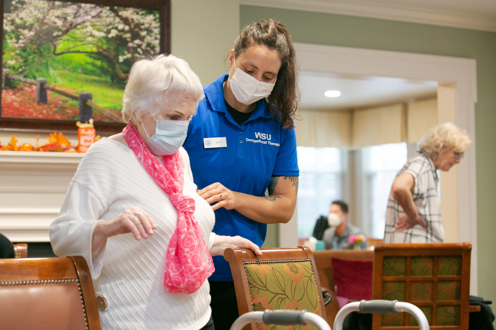 a college student assists a resident