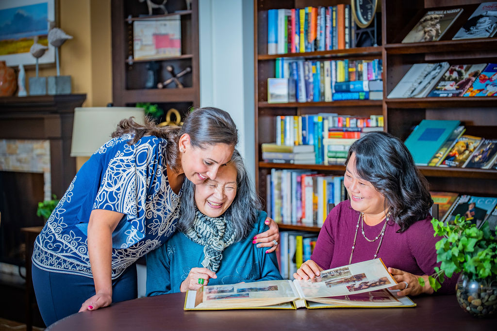 Senior women and associates reading a book