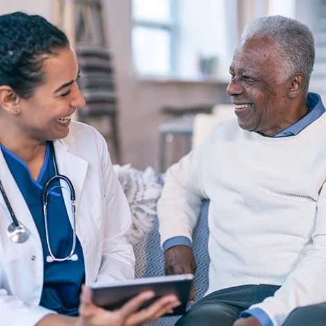 Female doctor speaking with older man