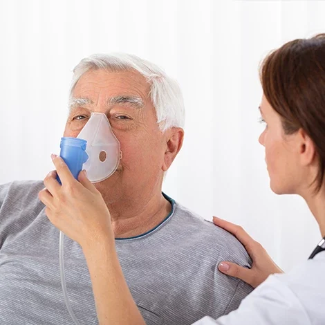 Nurse helping man with oxygen tank