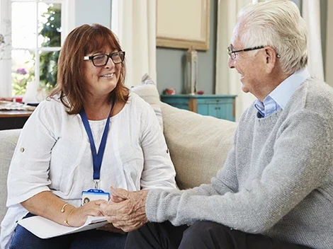 Nurse speaking with senior man