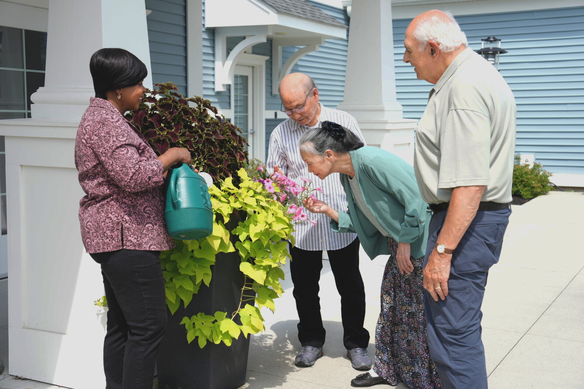 seniors looking and smelling flowers