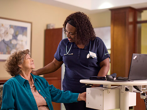 Nurse-resident A Benchmark associate speaking to a resident