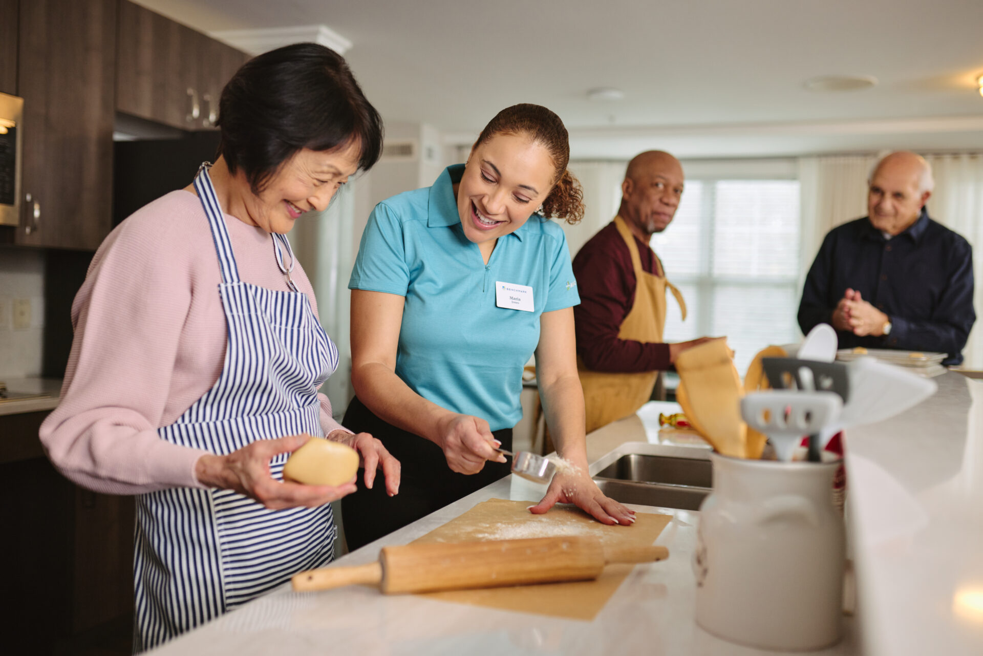 an associate and a senior baking a cake