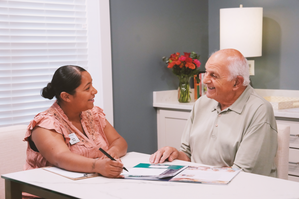 Benchmark Senior Living associate reviewing documents with a resident.