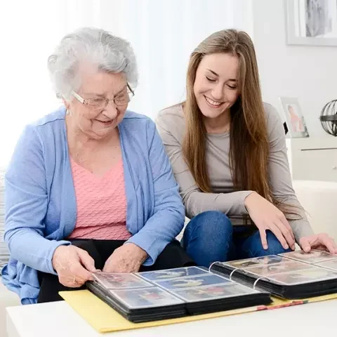 MC_circle.jpg (1) Senior woman and young woman looking at photo album